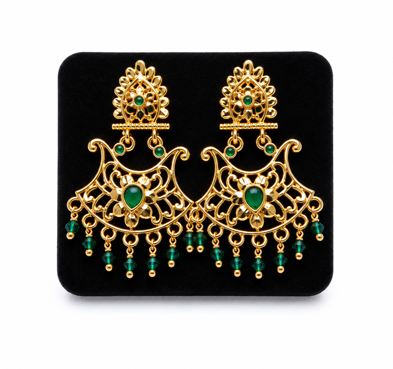 Ornate gold chandelier earrings with green gems